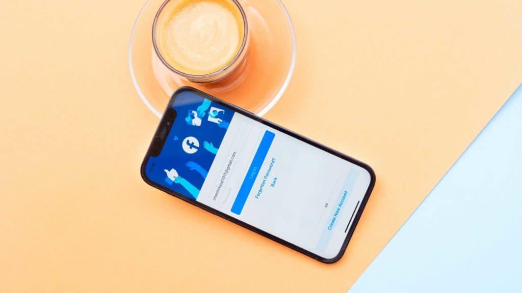 Phone with facebook page sign in on orange table