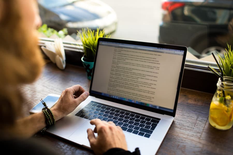 Man working on text file on computer