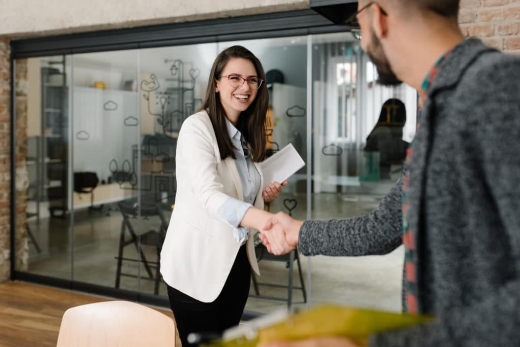 Business woman shaking man's hand