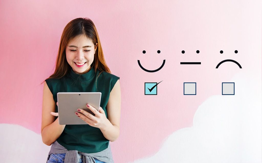 Woman on tablet rating experience as good