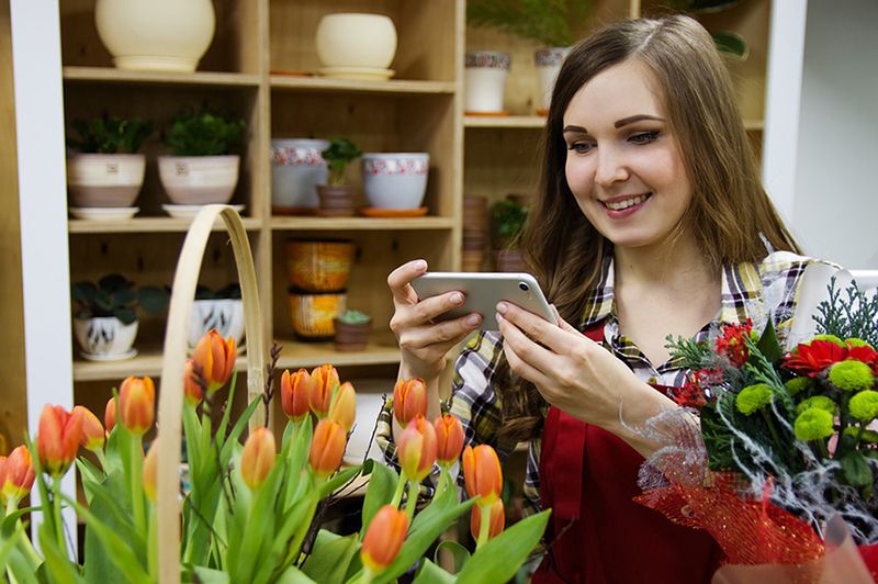 Florist taking photo of flowers