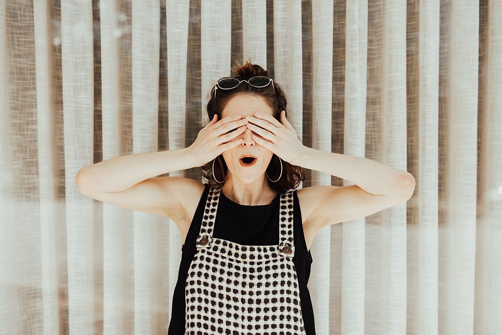 Girl covering eyes shocked by digital marketing mistake