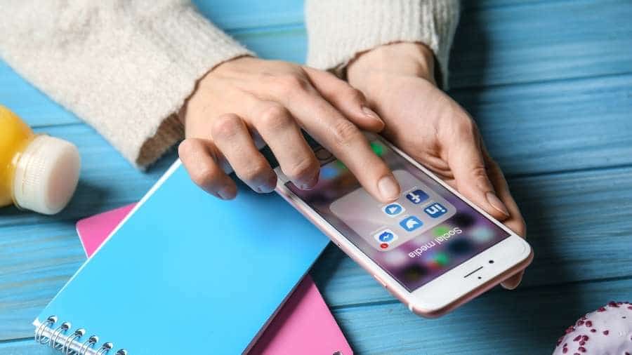 Person selecting twitter app