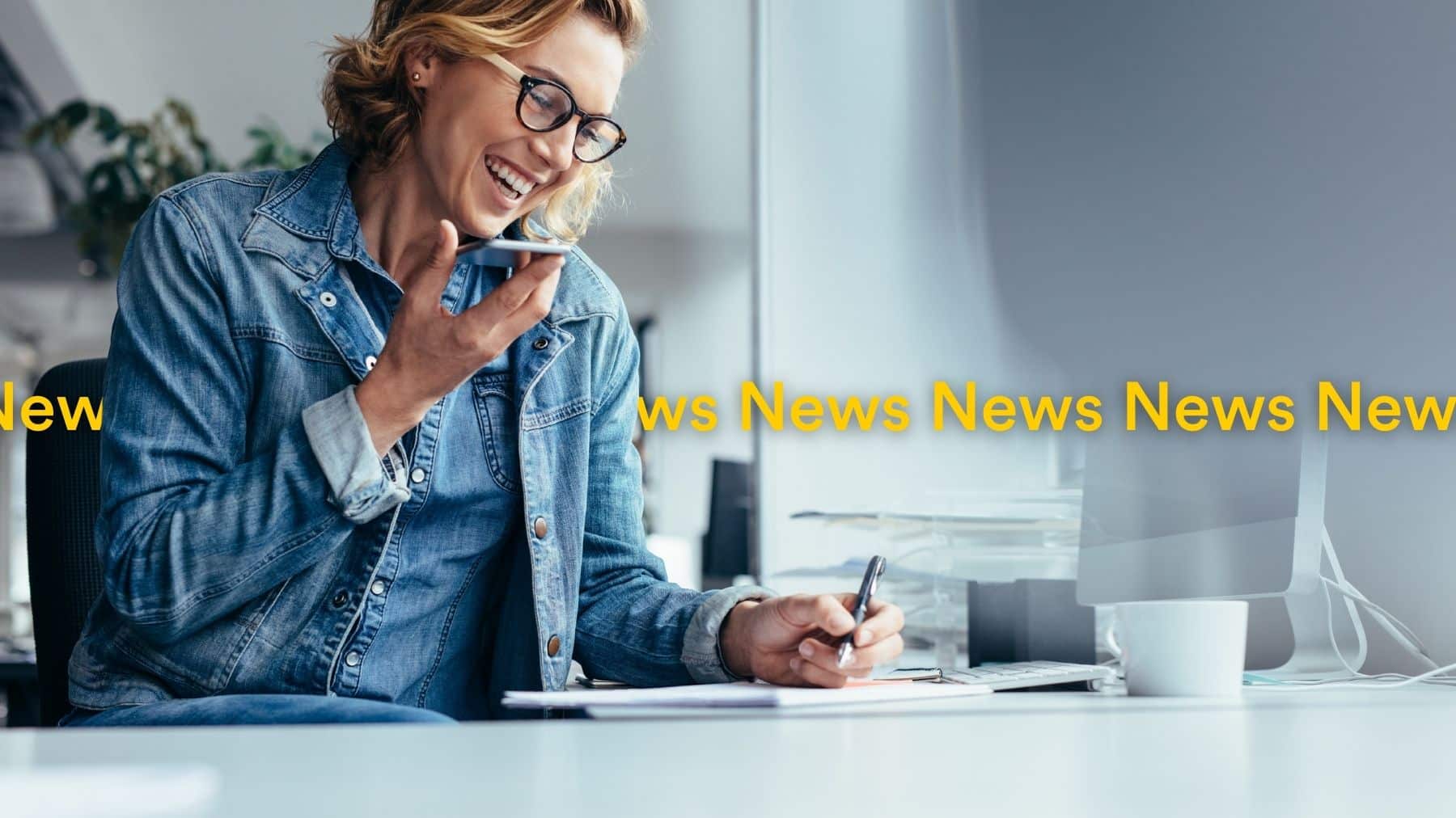 woman on phone with blue denim jacket while writing - Localsearch QLD