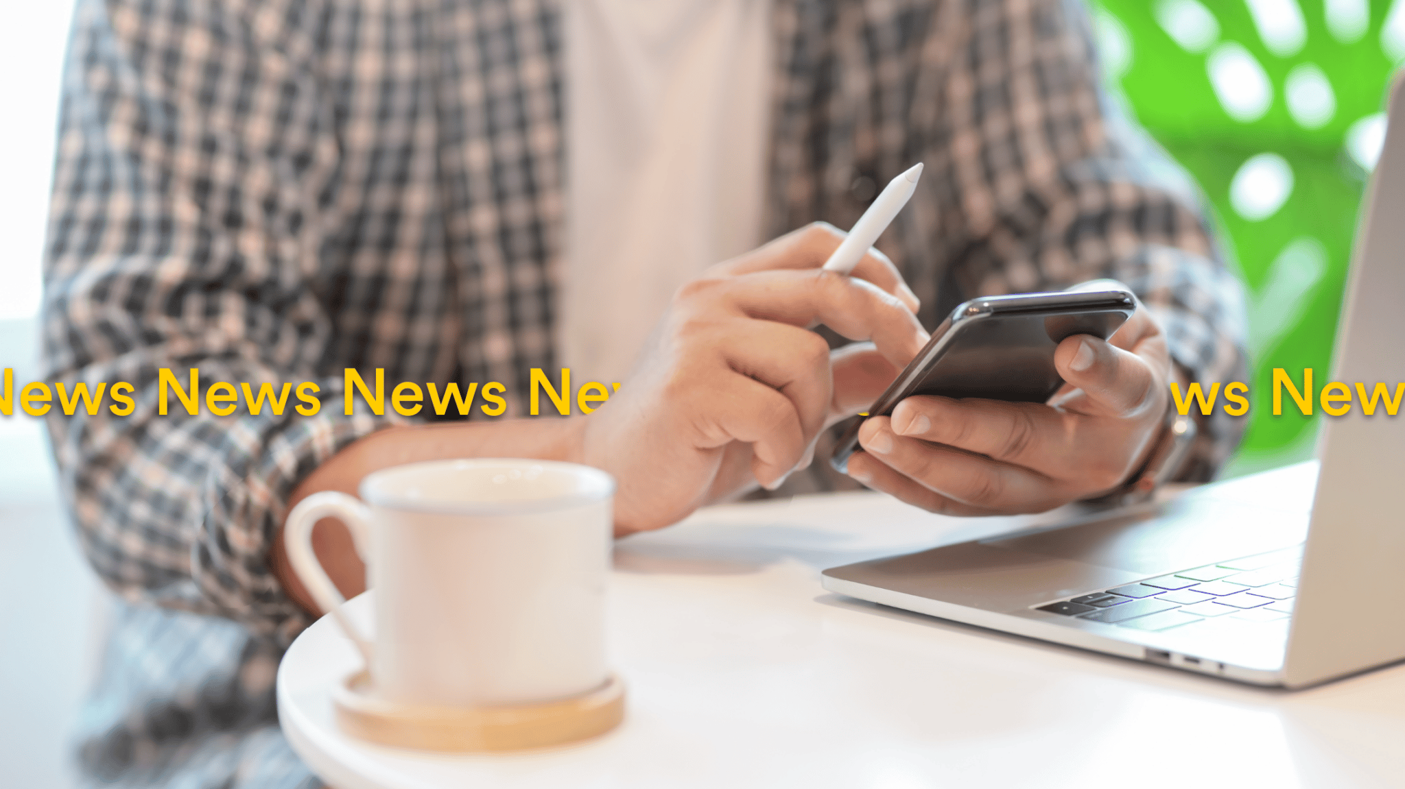 male working from home or cafe wearing flannel shirt looking up news on phone localsearch QLD