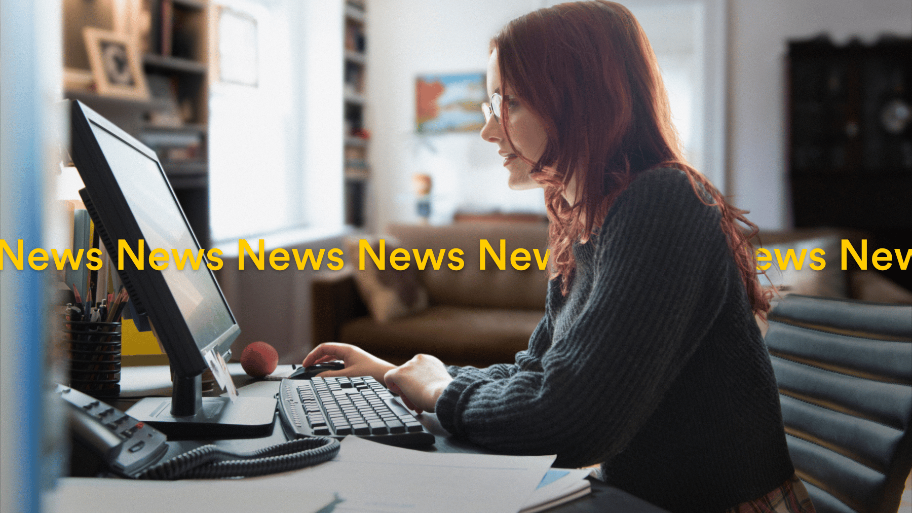 Women working from home red hair dark green jumper checking the news Localsearch QLD